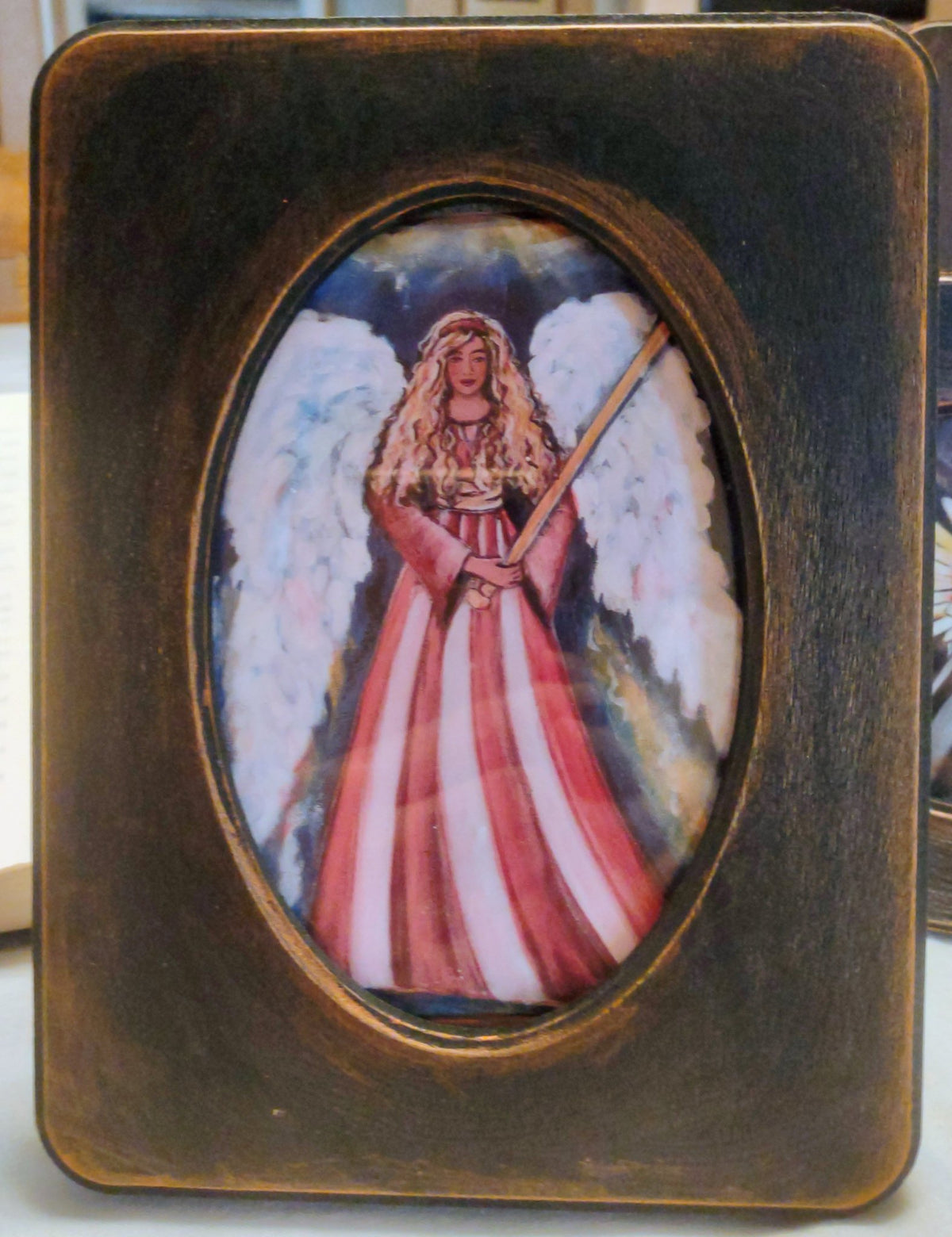 6a041d51b48fe50b080237df_warring-angel-in-5x7-frame_1784927002815.jpg