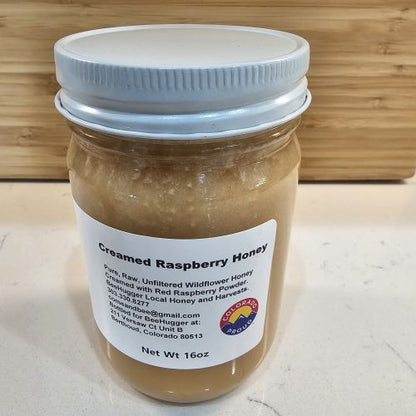6a041d51b48fe50b080237df_the-bee-hugger-creamed-raspberry-honey-side_1784469323584.jpg